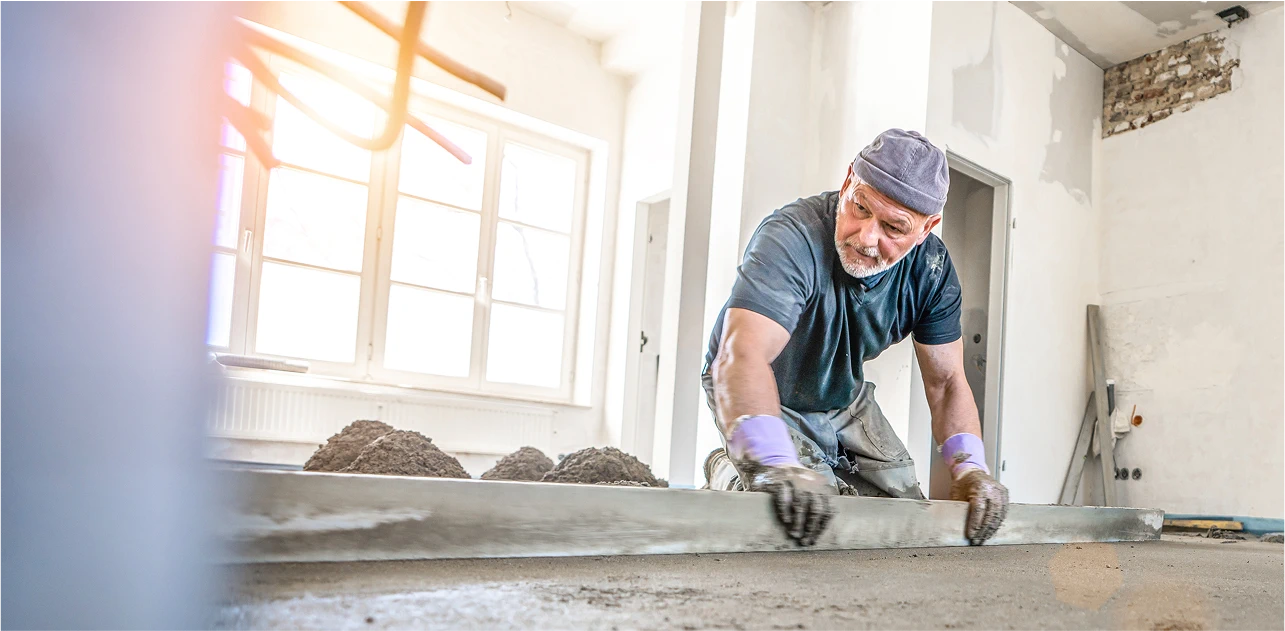 Image of man screeding concrete